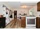 Open kitchen layout with stainless appliances, wood cabinets, and wood-look flooring at 8808 Rocky Hill Rd, Indianapolis, IN 46217
