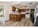 Well-lit kitchen featuring wood cabinets, white countertops, and wood-look flooring at 8808 Rocky Hill Rd, Indianapolis, IN 46217