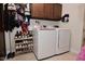 Laundry room featuring white washer and dryer, overhead cabinets, and tile floors at 8808 Rocky Hill Rd, Indianapolis, IN 46217