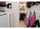 Laundry room featuring white washer and dryer next to powder room, overhead cabinets, and tile floors at 8808 Rocky Hill Rd, Indianapolis, IN 46217