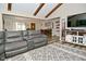 Comfortable living room featuring a reclining sofa, entertainment center, and open layout at 8808 Rocky Hill Rd, Indianapolis, IN 46217