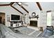 Inviting living room with vaulted ceilings, wood beams, fireplace, and stylish gray accent rug at 8808 Rocky Hill Rd, Indianapolis, IN 46217