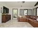 Living room featuring many windows, tile floor, and comfortable leather sofa at 8808 Rocky Hill Rd, Indianapolis, IN 46217