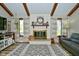 Bright living room with wood-look floors, a brick fireplace, and vaulted ceilings at 8808 Rocky Hill Rd, Indianapolis, IN 46217