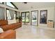 Bright living room featuring tile flooring, large windows, and a comfortable leather sofa at 8808 Rocky Hill Rd, Indianapolis, IN 46217