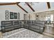 Spacious living room with beamed ceilings, a large sectional sofa, and an accent rug at 8808 Rocky Hill Rd, Indianapolis, IN 46217