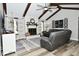 Cozy living room with wood-look flooring, fireplace, and vaulted ceilings at 8808 Rocky Hill Rd, Indianapolis, IN 46217
