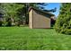 A backyard shed with a clean design situated on a vibrant green lawn under a clear blue sky at 8808 Rocky Hill Rd, Indianapolis, IN 46217