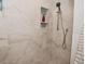 Modern shower with white marble tile, a built-in niche, and a rainfall shower head at 8808 Rocky Hill Rd, Indianapolis, IN 46217