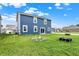 Spacious backyard showing a well-maintained lawn and view of the charming blue home at 8961 Fitzgerald Dr, Indianapolis, IN 46239