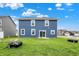 Expansive backyard features lush lawn and a charming blue home, perfect for outdoor enjoyment at 8961 Fitzgerald Dr, Indianapolis, IN 46239
