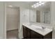 Bathroom features a double sink vanity with a dark wood finish, bright lighting, and a walk in closet at 8961 Fitzgerald Dr, Indianapolis, IN 46239