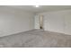 Large bonus room with carpet flooring, several entry doors, and plenty of natural light at 8961 Fitzgerald Dr, Indianapolis, IN 46239