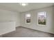 Well-lit room with plush carpeting, neutral walls, and a dual window setup providing natural light at 8961 Fitzgerald Dr, Indianapolis, IN 46239
