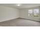 Neutral room with plush carpeting, a single window offering neighborhood views and ample space at 8961 Fitzgerald Dr, Indianapolis, IN 46239
