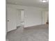Carpeted bonus room featuring two entry doors and access to other rooms in the home at 8961 Fitzgerald Dr, Indianapolis, IN 46239