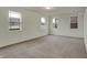 Spacious bedroom with neutral carpet, three windows, and ample natural light at 8961 Fitzgerald Dr, Indianapolis, IN 46239