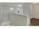 Bright hallway featuring white walls, plush carpeting and an adjacent laundry room for added convenience at 8961 Fitzgerald Dr, Indianapolis, IN 46239
