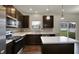 Well-equipped kitchen featuring sleek appliances, dark cabinets, and a cozy breakfast bar, ready for Gathering gatherings at 8961 Fitzgerald Dr, Indianapolis, IN 46239