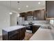 The kitchen boasts dark cabinets, stainless steel appliances, and a center island, blending style with functionality at 8961 Fitzgerald Dr, Indianapolis, IN 46239
