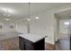 The kitchen showcases modern pendant lighting and an island perfect for entertaining in the open concept space at 8961 Fitzgerald Dr, Indianapolis, IN 46239