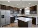 The kitchen boasts stainless steel appliances, dark cabinets, and a large island, ideal for modern living at 8961 Fitzgerald Dr, Indianapolis, IN 46239