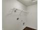 The laundry room features white walls, wood-look flooring, and shelving ready for your personal touch at 8961 Fitzgerald Dr, Indianapolis, IN 46239