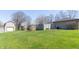 A spacious backyard with a lush green lawn, shed, and wood fence at 918 N 700 W, Greenfield, IN 46140