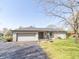 Charming single-story home featuring stone facade, attached garage and well-manicured lawn at 918 N 700 W, Greenfield, IN 46140