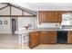 Bright eat-in kitchen with wood cabinets, a black dishwasher, and breakfast bar at 918 N 700 W, Greenfield, IN 46140