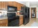 Kitchen with wood cabinets and black appliances at 918 N 700 W, Greenfield, IN 46140