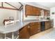 Bright eat-in kitchen featuring wood cabinets, gray countertops, and black dishwasher at 918 N 700 W, Greenfield, IN 46140