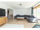 Bright living room features a gray sectional sofa, wood floors, and large window at 918 N 700 W, Greenfield, IN 46140