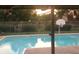 Backyard pool featuring ambient outdoor lighting, creating a perfect oasis for evening relaxation and entertainment at 918 N 700 W, Greenfield, IN 46140