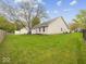 Expansive backyard with lush green lawn and mature trees surrounding a well-maintained home at 936 Eagle Brook Cir, Shelbyville, IN 46176