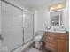 Modern bathroom featuring a glass shower, wood-style vanity, and updated fixtures at 936 Eagle Brook Cir, Shelbyville, IN 46176