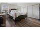 Bedroom featuring wood flooring, a large bed, and a closet at 936 Eagle Brook Cir, Shelbyville, IN 46176