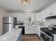 Well-equipped kitchen featuring white cabinets, stainless steel appliances, and an island at 936 Eagle Brook Cir, Shelbyville, IN 46176