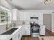 Bright kitchen with white cabinetry, stainless steel appliances, and quartz countertops at 936 Eagle Brook Cir, Shelbyville, IN 46176