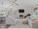 Bright living room with a fireplace, vaulted ceilings, and hardwood floors at 936 Eagle Brook Cir, Shelbyville, IN 46176