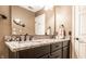 Bathroom featuring dual sinks with a granite countertop, updated fixtures and a decorative mirror at 9609 Highgate N Cir, Indianapolis, IN 46250
