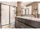 Well-lit bathroom featuring a glass-door shower, granite countertop, and modern fixtures at 9609 Highgate N Cir, Indianapolis, IN 46250