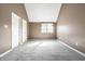Bedroom with a vaulted ceiling, neutral carpet, and natural light streaming through the window at 9609 Highgate N Cir, Indianapolis, IN 46250