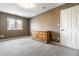 Bedroom featuring neutral paint, a dresser, carpet, a window and a white door at 9609 Highgate N Cir, Indianapolis, IN 46250
