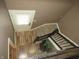 Entryway looking down from upper level, showcasing wood-look floors, stairs, and landing at 9609 Highgate N Cir, Indianapolis, IN 46250