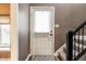 Bright entryway featuring neutral walls, decorative lighting, and stair access to the upper levels at 9609 Highgate N Cir, Indianapolis, IN 46250