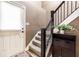 Neutral entryway featuring stairs with dark banister and access to upper levels at 9609 Highgate N Cir, Indianapolis, IN 46250