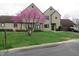 Charming two-story home with inviting curb appeal and blossoming tree at 9609 Highgate N Cir, Indianapolis, IN 46250