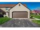 Two-story home showcasing a garage and a paved driveway at 9609 Highgate N Cir, Indianapolis, IN 46250