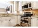 Updated kitchen featuring stainless steel appliances, granite countertops, and ample cabinet space at 9609 Highgate N Cir, Indianapolis, IN 46250